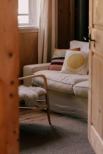 a living room with a couch and a chair at Sandbur Das Walserhaus in Lech am Arlberg