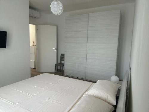 a bedroom with a white bed in a room at Appartamento BELVEDERE in Castiglione Olona