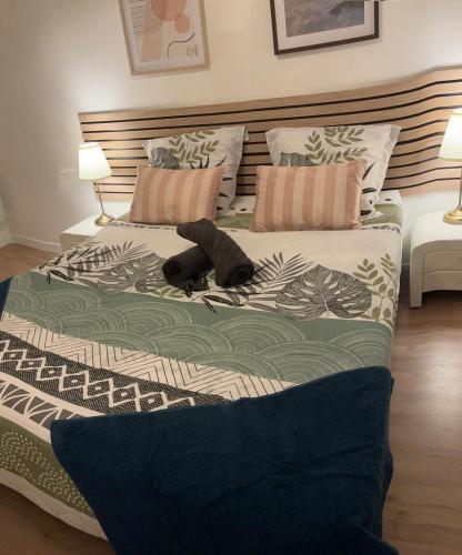 a dog laying on a bed in a bedroom at Astou Cisse in Marseille