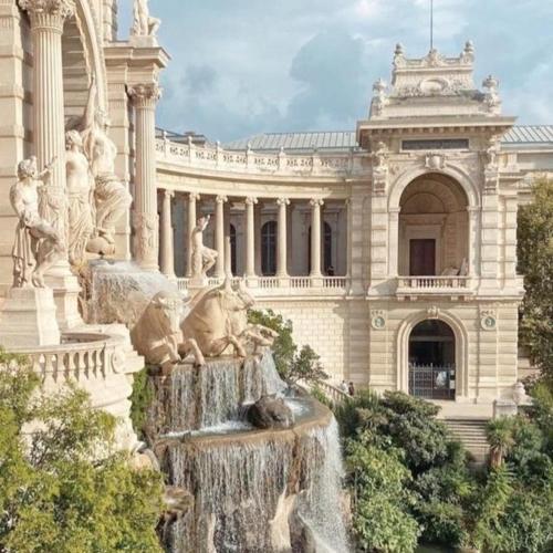 a large building with a fountain in front of a building at Astou Cisse in Marseille