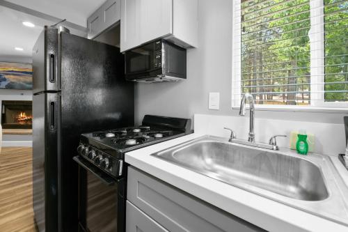 a kitchen with a sink and a stove at Big Bear Frontier in Big Bear Lake
