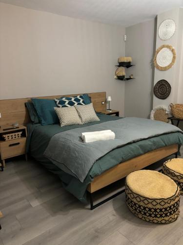 - une chambre avec un grand lit et deux tabourets dans l'établissement Villa ELEMIAH, à Saint-Tropez