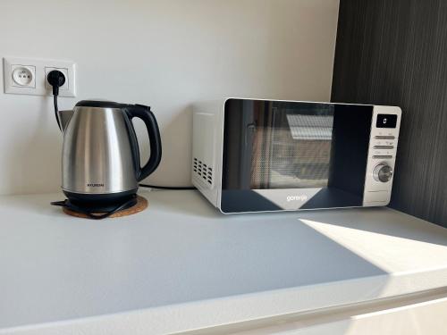 a microwave sitting on a counter next to a toaster oven at Hillside Y34 in Dolný Kubín