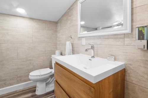 a bathroom with a white sink and a toilet at Big Bear Frontier in Big Bear Lake