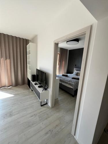 a bedroom with a bed and a television and a mirror at Hillside Y34 in Dolný Kubín