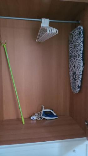 a room with a shelf with a lamp and a green object at Cavour3 in Nettuno