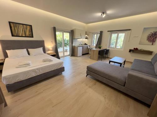 a large bedroom with a bed and a couch at AZOGIRE Resort in Azoyirés
