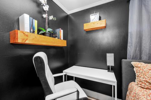 a black room with a desk and a chair at Charming Urban Studio Near Rice University & Museum District in Houston