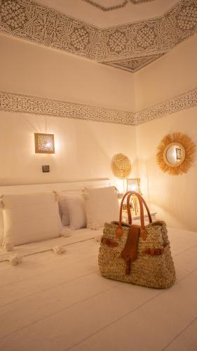 a bedroom with a bed with a bag on it at Dar Salam Palm - Guest Choice Award 2024 in Marrakech