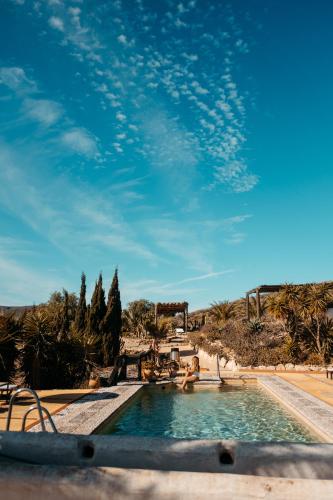 a swimming pool in the middle of the desert at Cortijo Los Malenos in Agua Amarga