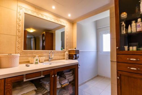 a bathroom with a sink and a mirror at Astali Villa in Stalida