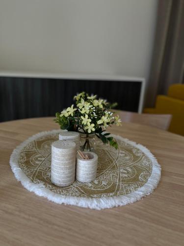 a table with a centerpiece with a vase of flowers at Hillside Y34 in Dolný Kubín