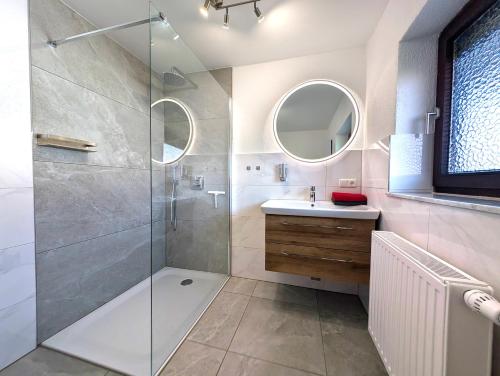 a bathroom with a shower and a sink at Ferienwohnung Alpenglut in Nesselwang