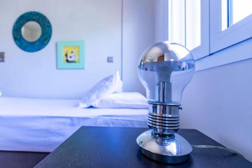 a light bulb sitting on a table in a bedroom at Astali Villa in Stalida