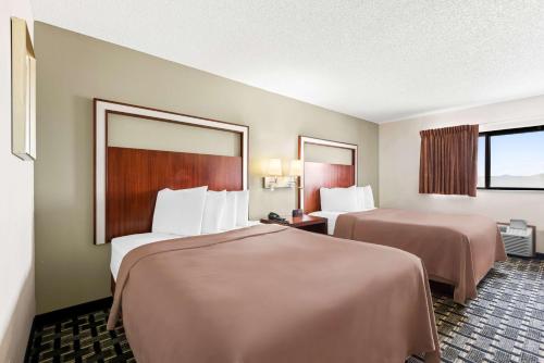 a hotel room with two beds and a window at SureStay Hotel by Best Western Manchester in Manchester