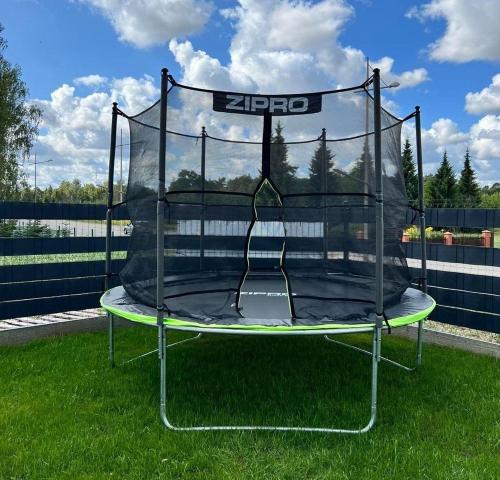 a trampoline on the grass in a yard at Mazurskie Niebo Apartament 2 in Gołdap