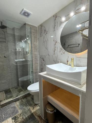 a bathroom with a sink and a shower and a toilet at La Puerta Blanca #2 in Puerto Vallarta