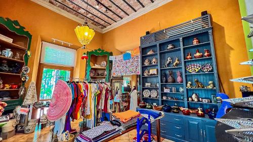 a shop with blue cabinets and shelves with merchandise at Hotel Boutique Casa San Angel in Mérida