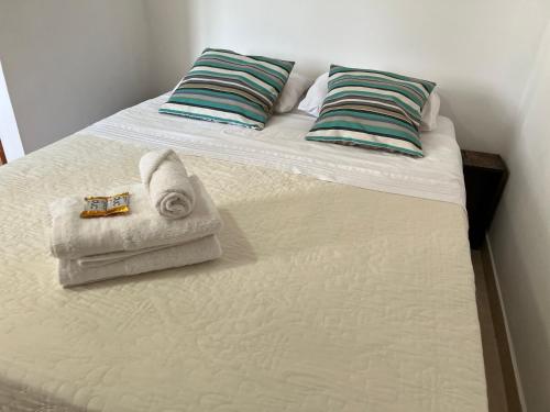 a bed with towels and pillows on it at Departamento Centrico Iguazu 2A in Puerto Iguazú