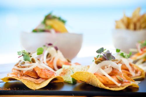a plate of food with nachos on a table at Kimpton - Grand Roatan Resort and Spa in West Bay