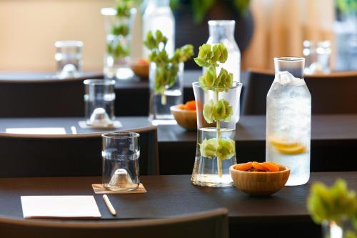 a table with several bottles and a bowl of oranges at Kimpton - Grand Roatan Resort and Spa in West Bay