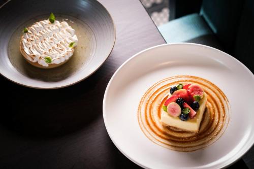 two plates of food sitting on a table at Kimpton - Grand Roatan Resort and Spa in West Bay
