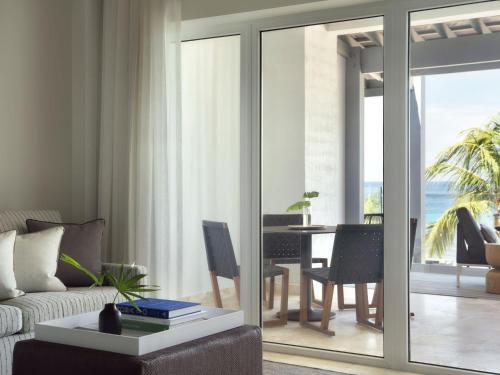 a living room with a couch and a table at Kimpton - Grand Roatan Resort and Spa in West Bay