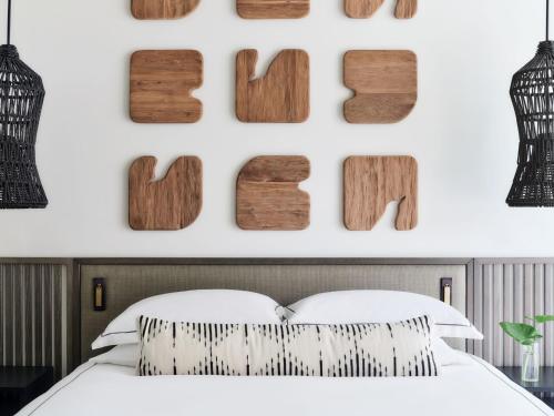 a bedroom with wood numbers on the wall at Kimpton - Grand Roatan Resort and Spa in West Bay