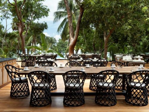 a large wooden table and chairs on a deck at Kimpton - Grand Roatan Resort and Spa in West Bay