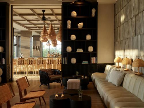 a living room with a couch and chairs and tables at Kimpton - Grand Roatan Resort and Spa in West Bay