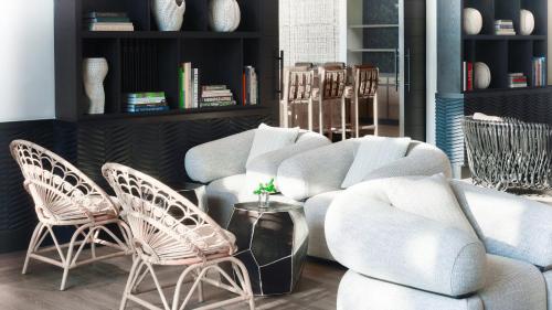 a living room with two chairs and a couch at Kimpton - Grand Roatan Resort and Spa in West Bay