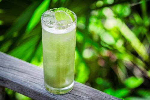 a drink with a lime in a glass at Kimpton - Grand Roatan Resort and Spa in West Bay