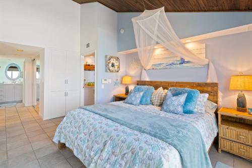a bedroom with a bed with a blue comforter at Picturesque Perfection in Leucadia Encinitas in Encinitas