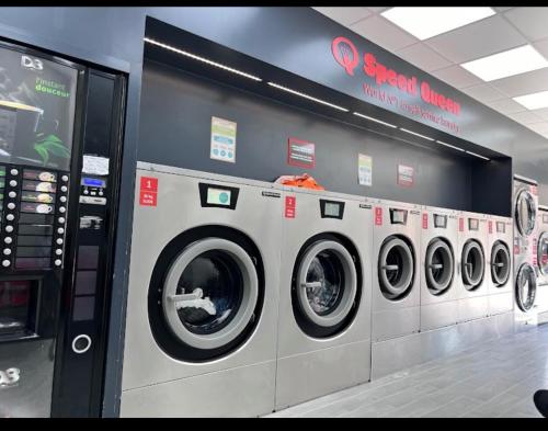 a row of washing machines in a store at Spacieux et confortable appartement en résidence in Pontoise