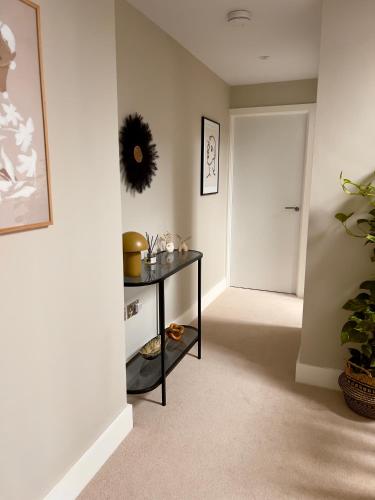 a hallway with a black table and a white door at Lambert House in Harrogate