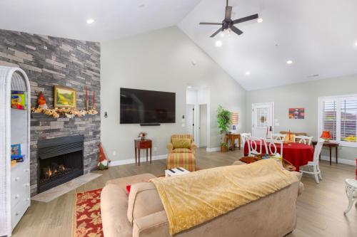 a living room with a couch and a fireplace at Deep Creek Retreat Hot Tub 85 inchTV all one level in Accident