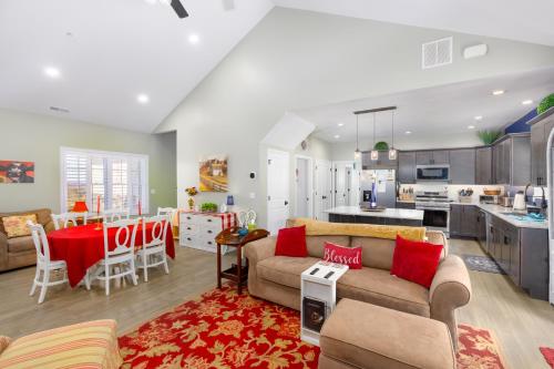 a living room and kitchen with a couch and a table at Deep Creek Retreat Hot Tub 85 inchTV all one level in Accident