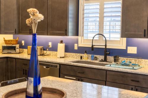 a kitchen with a blue vase on a counter at Deep Creek Retreat Hot Tub 85 inchTV all one level in Accident