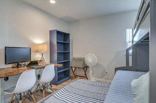 a bedroom with a desk with a computer and a bed at Walk to Sand Surfside Beach Getaway with Deck in Freeport