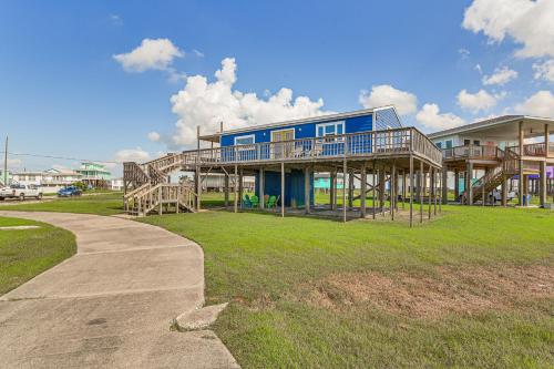 a large blue house with a porch and a sidewalk at Walk to Sand Surfside Beach Getaway with Deck in Freeport