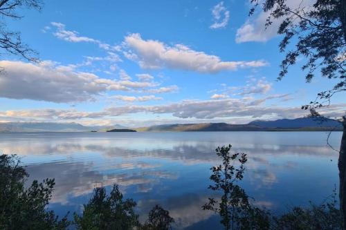 a view of a lake with clouds in the sky at House on Calafquen lake in Panguipulli