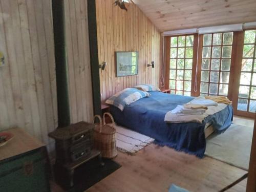 a bedroom with a bed in a wooden cabin at House on Calafquen lake in Panguipulli