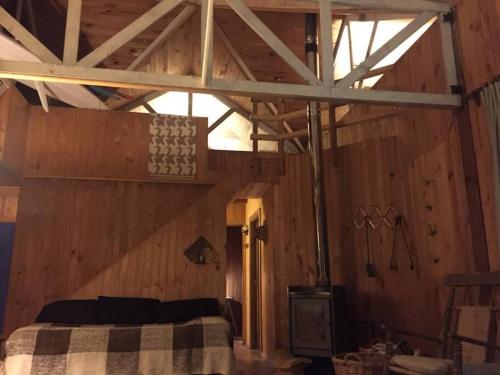 a bedroom with a bed in a wooden room at House on Calafquen lake in Panguipulli
