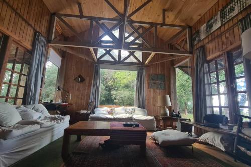 a living room with a couch and a table at House on Calafquen lake in Panguipulli