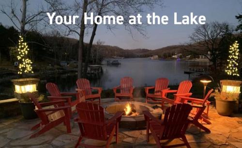 your home at the lake with chairs around a fire pit at Pebble Bay Club Suites in Camdenton