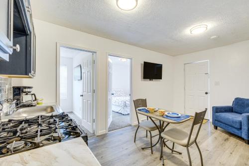 a kitchen with a stove and a table with chairs at Walkable Barberton Apartment 9 Mi to Akron! in Barberton