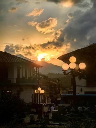a sunset with a group of street lights in a town at Hotel Colonial in Jardin