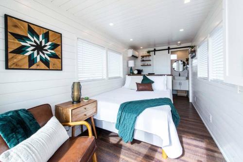 a bedroom with a bed and a couch at The Stardust Stunning Container Home in Alpine
