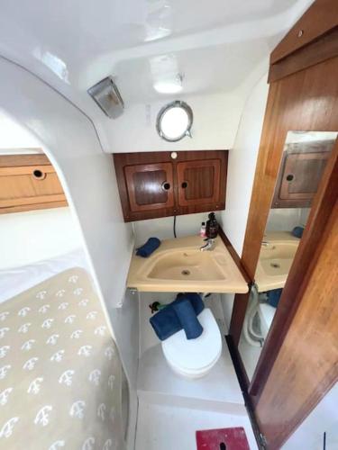 a small bathroom with a sink and a toilet at Vintage sailboat experience in Lisbon