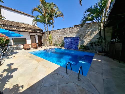 a swimming pool in the backyard of a house at Pousada Doce Paraty in Paraty